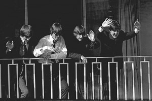 The Beatles wave from a balcony