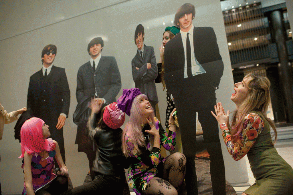 Colorful fans genuflect in front of cutouts at Beatlefest NYC, February 7, 2014. @ Andy Kropa.