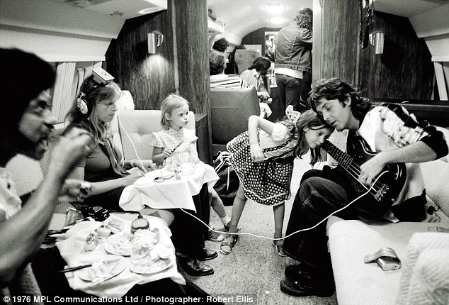 Paul McCartney and family in plane, 1976