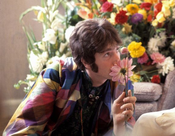 Lennon smelling a daisy